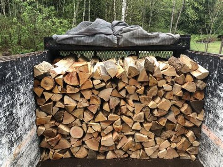 Where should firewood be stacked?
